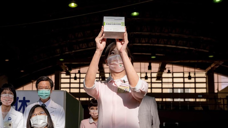 In this photo released by the Taiwan Presidential Office, Taiwanese President Tsai Ing-wen, center, receives her first shot of the island's first domestically developed coronavirus vaccine made by Medigen Vaccine Biologics Corp. at the Taiwan University Hospital in Taipei, Taiwan on Monday, Aug. 23, 2021. The vaccine was given emergency approval by regulators in July using a shortcut that prompted fierce opposition from parts of Taiwan's medical and scientific community. (Taiwan Presidential Office via AP)