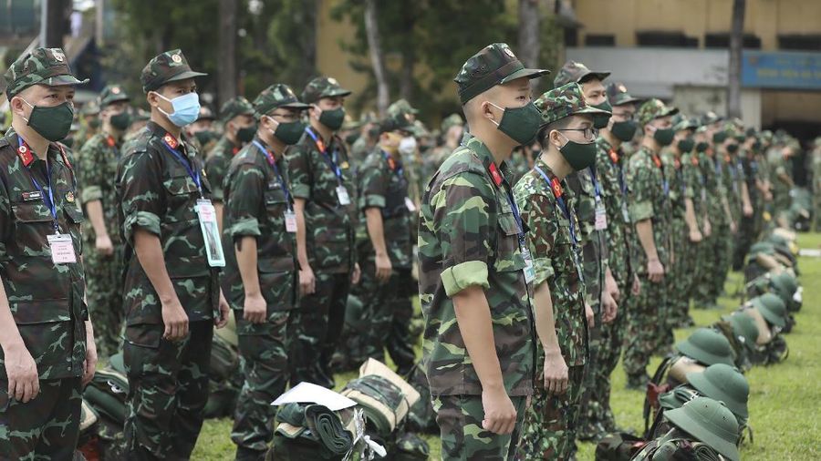 Army soldiers line up during a ceremony to send off military doctors to Ho Chi Minh City to help with treating COVID-19 patients in Hanoi, Vietnam, Monday, Aug. 23, 2021. Vietnam's largest metropolis Ho Chi Minh City has enabled a strict lockdown order to help curb the recent outbreak of the pandemic. (Bui Cuong Quyet/VNA via AP)