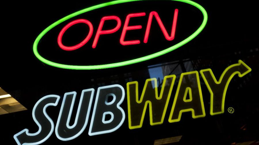 FILE- In this Oct. 24, 2016, file photo, a Subway fast food restaurant's sign is shown in New York. Subway is changing up its loyalty program, letting customers earn $2 discounts instead of free Footlong sandwiches. The change, taking place in March 2018, is part of Subway’s plan to lure people back to the sandwich chain. (AP Photo/Mark Lennihan, File)