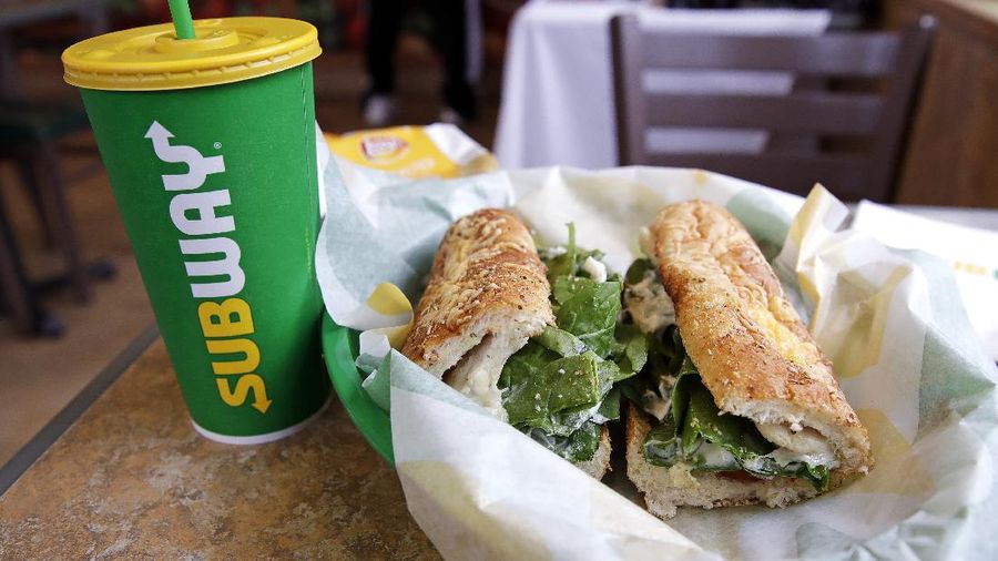 The Subway logo is seen on on a soft drink cup next to a sandwich at a restaurant in Londonderry, N.H., Friday, Feb. 23, 2018. Subway is shaking up its loyalty rewards program, giving customers the ability to earn $2 discounts instead of free Footlongs.
(AP Photo/Charles Krupa)