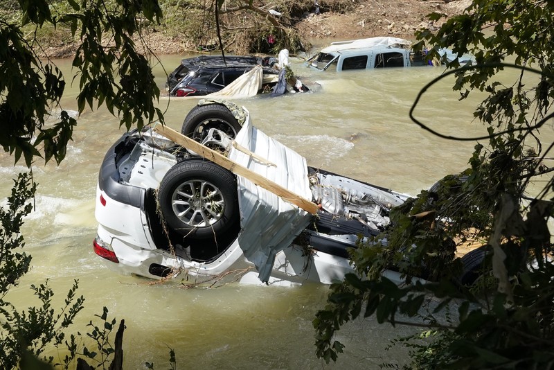 APTOPIX Tennessee Flooding Cars are stacked on top of each other on the banks of Blue Creek being swept up in flood water, Monday, Aug. 23, 2021, in Waverly, Tenn. Heavy rains caused flooding in Middle Tennessee days ago and have resulted in multiple deaths as homes and rural roads were washed away. (AP Photo/John Amis)