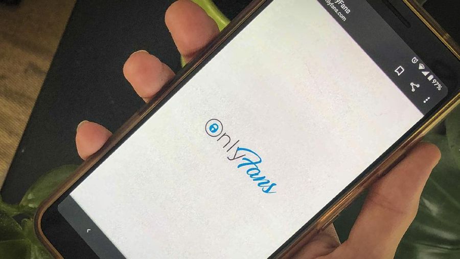 This photo shows a phone app for OnlyFans, a site where fans pay creators for their photos and videos, Thursday Aug. 19, 2021. A spokesperson says the site will ban 