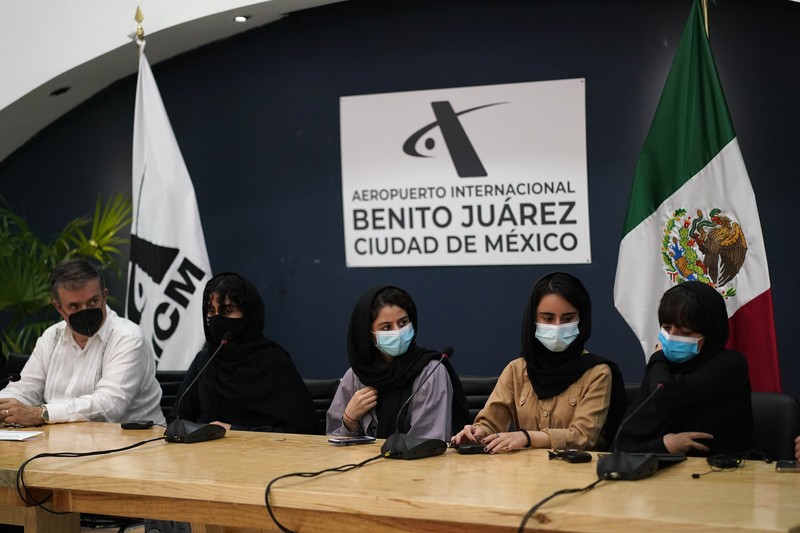Several of the original members of the Afghan all-girls robotics team, who have received threats from the Taliban, attend a press conference after arriving at the Benito Juarez International Airport in Mexico City, Tuesday, Aug. 24, 2021. After extensive international efforts and coordination from a diverse group of volunteers to evacuate the team, the girls are now begging the international community to help get their family to safety with them. (AP Photo/Eduardo Verdugo)