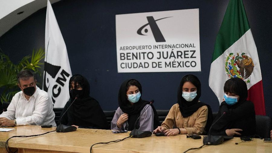 Several of the original members of the Afghan all-girls robotics team, who have received threats from the Taliban, attend a press conference after arriving at the Benito Juarez International Airport in Mexico City, Tuesday, Aug. 24, 2021. After extensive international efforts and coordination from a diverse group of volunteers to evacuate the team, the girls are now begging the international community to help get their family to safety with them. (AP Photo/Eduardo Verdugo)