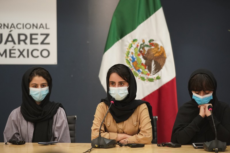 Several of the original members of the Afghan all-girls robotics team, who have received threats from the Taliban, attend a press conference after arriving at the Benito Juarez International Airport in Mexico City, Tuesday, Aug. 24, 2021. After extensive international efforts and coordination from a diverse group of volunteers to evacuate the team, the girls are now begging the international community to help get their family to safety with them. (AP Photo/Eduardo Verdugo)