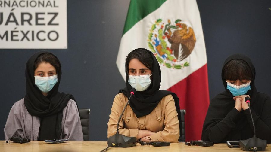 Several of the original members of the Afghan all-girls robotics team, who have received threats from the Taliban, attend a press conference after arriving at the Benito Juarez International Airport in Mexico City, Tuesday, Aug. 24, 2021. After extensive international efforts and coordination from a diverse group of volunteers to evacuate the team, the girls are now begging the international community to help get their family to safety with them. (AP Photo/Eduardo Verdugo)