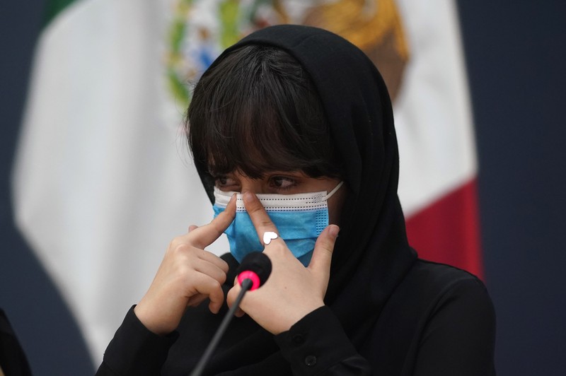 Several of the original members of the Afghan all-girls robotics team, who have received threats from the Taliban, attend a press conference after arriving at the Benito Juarez International Airport in Mexico City, Tuesday, Aug. 24, 2021. After extensive international efforts and coordination from a diverse group of volunteers to evacuate the team, the girls are now begging the international community to help get their family to safety with them. (AP Photo/Eduardo Verdugo)