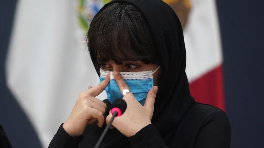Several of the original members of the Afghan all-girls robotics team, who have received threats from the Taliban, attend a press conference after arriving at the Benito Juarez International Airport in Mexico City, Tuesday, Aug. 24, 2021. After extensive international efforts and coordination from a diverse group of volunteers to evacuate the team, the girls are now begging the international community to help get their family to safety with them. (AP Photo/Eduardo Verdugo)