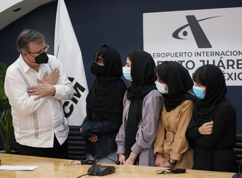 Several of the original members of the Afghan all-girls robotics team, who have received threats from the Taliban, attend a press conference after arriving at the Benito Juarez International Airport in Mexico City, Tuesday, Aug. 24, 2021. After extensive international efforts and coordination from a diverse group of volunteers to evacuate the team, the girls are now begging the international community to help get their family to safety with them. (AP Photo/Eduardo Verdugo)