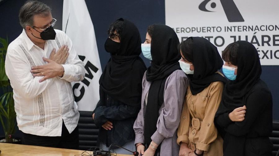 Several of the original members of the Afghan all-girls robotics team, who have received threats from the Taliban, attend a press conference after arriving at the Benito Juarez International Airport in Mexico City, Tuesday, Aug. 24, 2021. After extensive international efforts and coordination from a diverse group of volunteers to evacuate the team, the girls are now begging the international community to help get their family to safety with them. (AP Photo/Eduardo Verdugo)