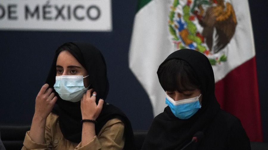 Several of the original members of the Afghan all-girls robotics team, who have received threats from the Taliban, attend a press conference after arriving at the Benito Juarez International Airport in Mexico City, Tuesday, Aug. 24, 2021. After extensive international efforts and coordination from a diverse group of volunteers to evacuate the team, the girls are now begging the international community to help get their family to safety with them. (AP Photo/Eduardo Verdugo)