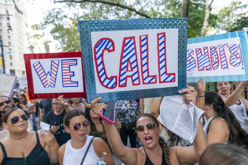 Virus Outbreak Vaccine Mandates Protesters hold their hands to their hearts during the national anthem at a demonstration against COVID-19 vaccination mandates, Wednesday, Aug. 25, 2021, in New York. (AP Photo/Mary Altaffer)