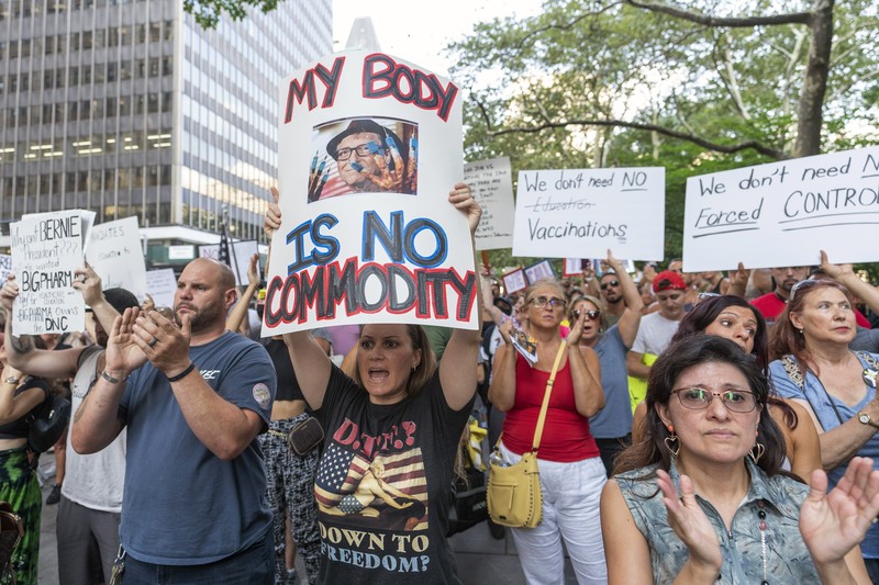 Virus Outbreak Vaccine Mandates Protesters hold their hands to their hearts during the national anthem at a demonstration against COVID-19 vaccination mandates, Wednesday, Aug. 25, 2021, in New York. (AP Photo/Mary Altaffer)