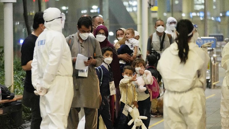 An Afghan girl in a bus waits to leave after arriving with her family at the Incheon International Airport, South Korea, Thursday, Aug. 26, 2021. (AP Photo/Ahn Young-joon)