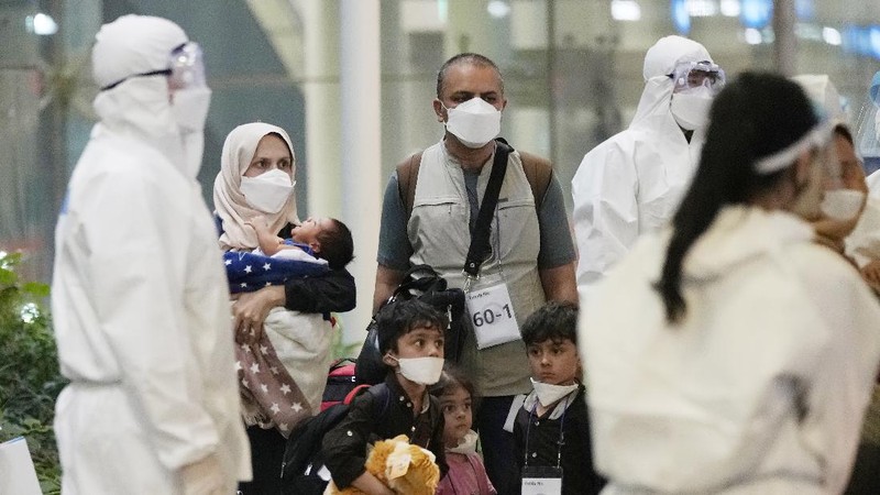 An Afghan girl in a bus waits to leave after arriving with her family at the Incheon International Airport, South Korea, Thursday, Aug. 26, 2021. (AP Photo/Ahn Young-joon)