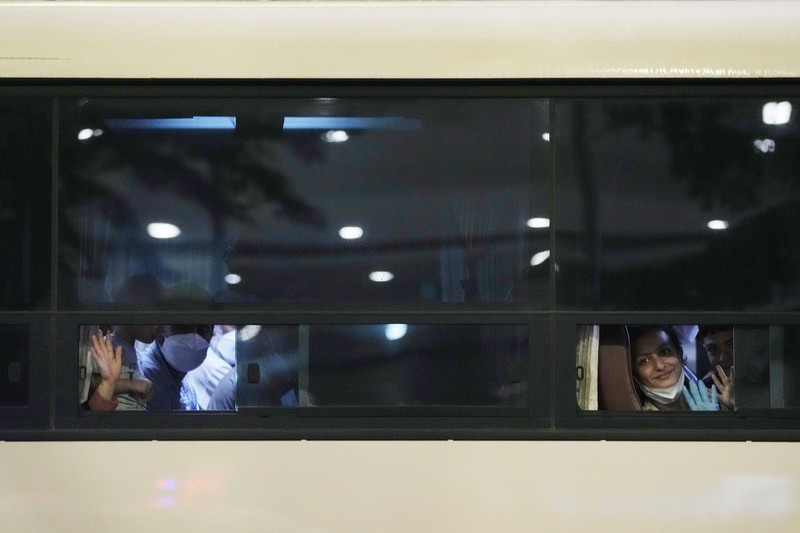 An Afghan girl in a bus waits to leave after arriving with her family at the Incheon International Airport, South Korea, Thursday, Aug. 26, 2021. (AP Photo/Ahn Young-joon)