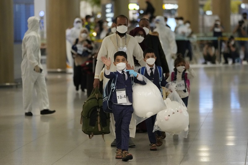 An Afghan girl in a bus waits to leave after arriving with her family at the Incheon International Airport, South Korea, Thursday, Aug. 26, 2021. (AP Photo/Ahn Young-joon)