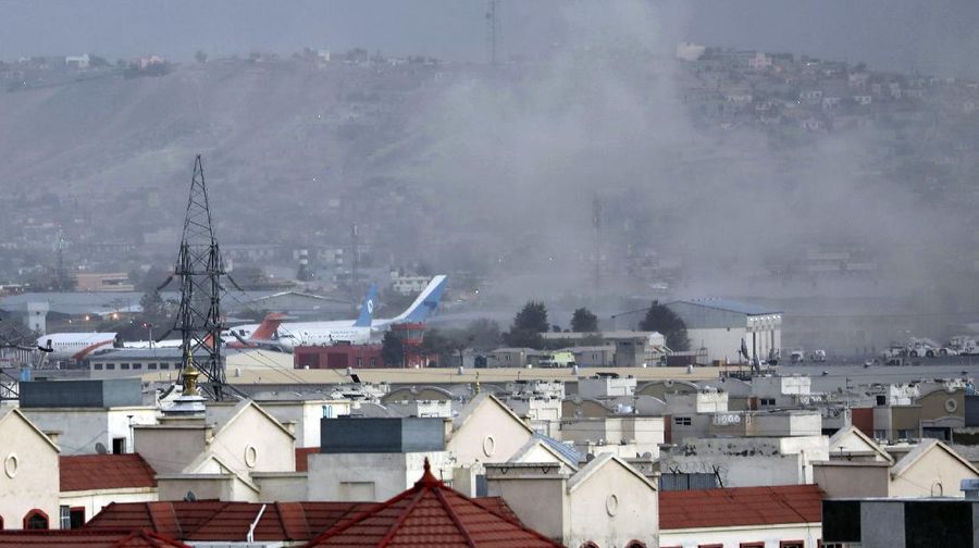 Smoke rises from a deadly explosion outside the airport in Kabul, Afghanistan, Thursday, Aug. 26, 2021. Two suicide bombers and gunmen have targeted crowds massing near the Kabul airport, in the waning days of a massive airlift that has drawn thousands of people seeking to flee the Taliban takeover of Afghanistan. (AP Photo/Wali Sabawoon)