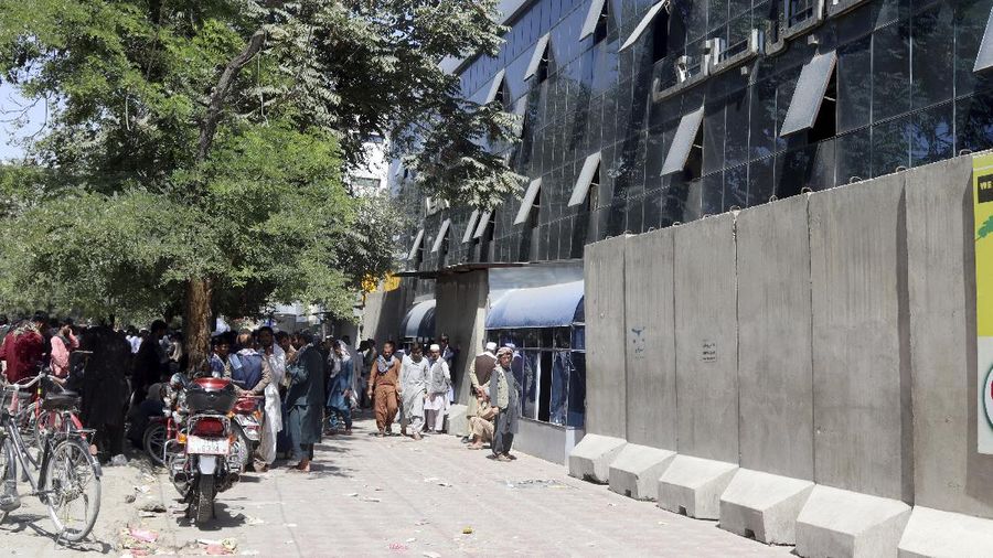 Afghans wait for hours to try to withdraw money, in front of Kabul Bank, in Kabul, Afghanistan, Saturday, Aug. 28, 2021. (AP Photo/Khwaja Tawfiq Sediqi)