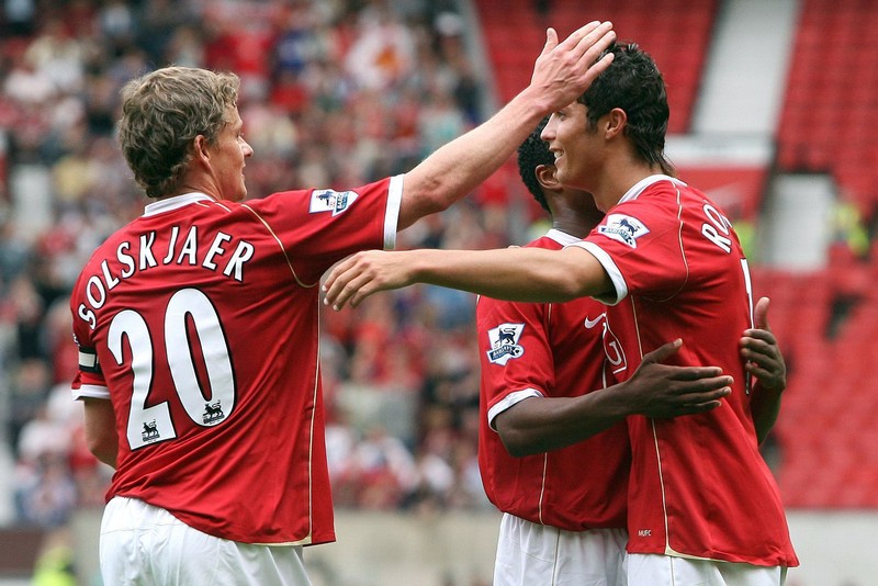 Man United Ronaldo's Return Soccer FILE - In this Aug. 12, 2006, file photo, Manchester United's Cristiano Ronaldo, right, celebrates scoring against Sevilla with Ole Gunnar Solskjaer and Patrice Evra during a soccer match in Manchester, England. Ronaldo is headed back to Manchester United. The English club said Friday, Aug. 27, 2021, it has reached an agreement with Juventus for the transfer of the 36-year-old Portugal forward, subject to agreement of personal terms, visa and a medical examination. (Martin Rickett/PA via AP)