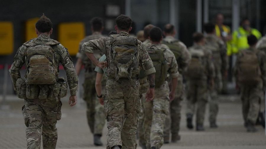 Members of the British armed forces 16 Air Assault Brigade walk to the air terminal after disembarking a RAF Voyager aircraft at Brize Norton, England, as they return from helping in operations to evacuate people from Kabul airport in Afghanistan, Saturday, Aug. 28, 2021. More than 100,000 people have been safely evacuated through the Kabul airport, according to the U.S., but thousands more are struggling to leave in one of history's biggest airlifts. (AP Photo/Alastair Grant, Pool)