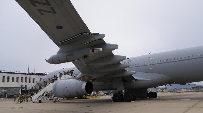 In this handout photo provided by the Ministry of Defence, UK military personnel onboard a A400M aircraft departing Kabul, Afghanistan, Saturday, Aug. 28, 2021. Britain has ended evacuation flights from Kabul airport and begun bringing U.K. troops home. Britain’s defense ministry said the final flight for Afghan citizens had left Kabul. Further flights over the weekend will bring home British troops and diplomats and a few remaining civilians. (Jonathan Gifford/Ministry of Defence via AP)