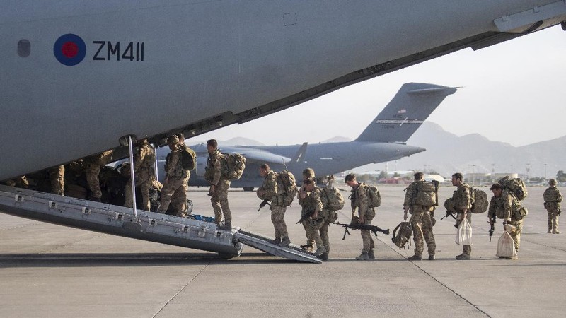 In this handout photo provided by the Ministry of Defence, UK military personnel onboard a A400M aircraft departing Kabul, Afghanistan, Saturday, Aug. 28, 2021. Britain has ended evacuation flights from Kabul airport and begun bringing U.K. troops home. Britain’s defense ministry said the final flight for Afghan citizens had left Kabul. Further flights over the weekend will bring home British troops and diplomats and a few remaining civilians. (Jonathan Gifford/Ministry of Defence via AP)