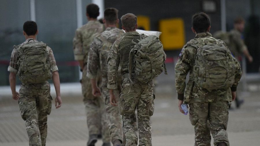 Members of the British armed forces 16 Air Assault Brigade walk to the air terminal after disembarking a RAF Voyager aircraft at Brize Norton, England, as they return from helping in operations to evacuate people from Kabul airport in Afghanistan, Saturday, Aug. 28, 2021. More than 100,000 people have been safely evacuated through the Kabul airport, according to the U.S., but thousands more are struggling to leave in one of history's biggest airlifts. (AP Photo/Alastair Grant, Pool)