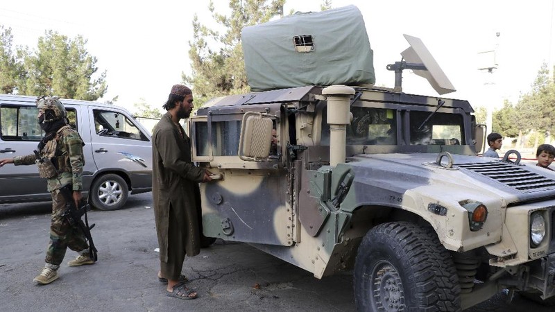 Taliban fighters stand guard at a checkpoint near the gate of Hamid Karzai international Airport in Kabul, Afghanistan, Saturday, Aug. 28, 2021.  The Taliban have sealed off Kabul’s airport to most would-be evacuees to prevent large crowds from gathering after this week's deadly suicide attack. The massive U.S.-led airlift was winding down Saturday ahead of a U.S. deadline to withdraw from Afghanistan by Tuesday. (AP Photo/Wali Sabawoon)