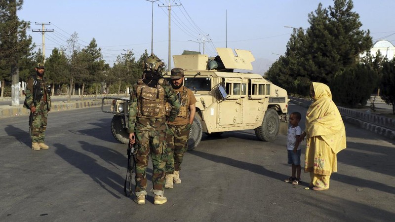 Taliban fighters stand guard at a checkpoint near the gate of Hamid Karzai international Airport in Kabul, Afghanistan, Saturday, Aug. 28, 2021.  The Taliban have sealed off Kabul’s airport to most would-be evacuees to prevent large crowds from gathering after this week's deadly suicide attack. The massive U.S.-led airlift was winding down Saturday ahead of a U.S. deadline to withdraw from Afghanistan by Tuesday. (AP Photo/Wali Sabawoon)