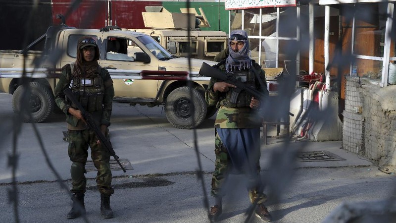 Taliban fighters stand guard at a checkpoint near the gate of Hamid Karzai international Airport in Kabul, Afghanistan, Saturday, Aug. 28, 2021.  The Taliban have sealed off Kabul’s airport to most would-be evacuees to prevent large crowds from gathering after this week's deadly suicide attack. The massive U.S.-led airlift was winding down Saturday ahead of a U.S. deadline to withdraw from Afghanistan by Tuesday. (AP Photo/Wali Sabawoon)