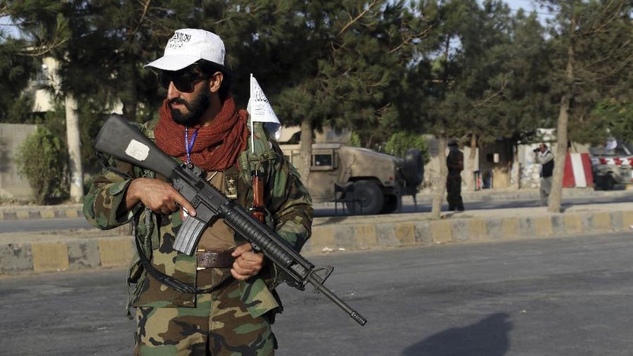 Taliban fighters stand guard at a checkpoint near the gate of Hamid Karzai international Airport in Kabul, Afghanistan, Saturday, Aug. 28, 2021.  The Taliban have sealed off Kabul’s airport to most would-be evacuees to prevent large crowds from gathering after this week's deadly suicide attack. The massive U.S.-led airlift was winding down Saturday ahead of a U.S. deadline to withdraw from Afghanistan by Tuesday. (AP Photo/Wali Sabawoon)