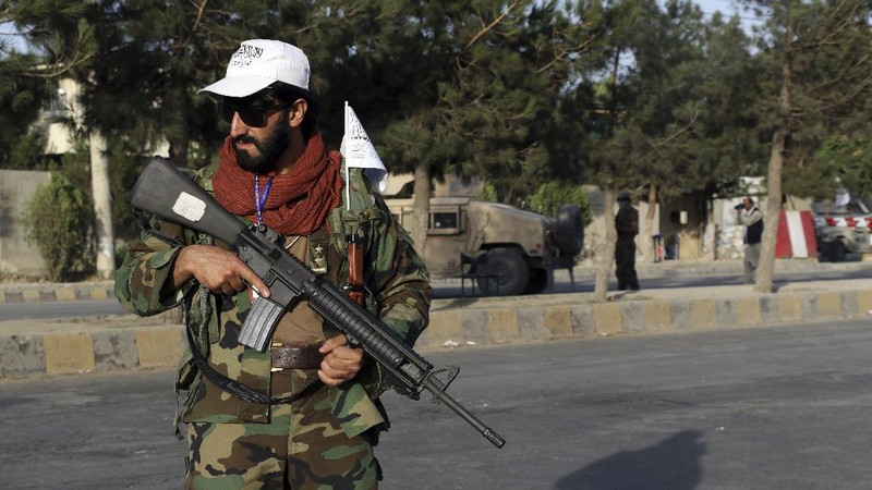 Taliban fighters stand guard at a checkpoint near the gate of Hamid Karzai international Airport in Kabul, Afghanistan, Saturday, Aug. 28, 2021.  The Taliban have sealed off Kabul’s airport to most would-be evacuees to prevent large crowds from gathering after this week's deadly suicide attack. The massive U.S.-led airlift was winding down Saturday ahead of a U.S. deadline to withdraw from Afghanistan by Tuesday. (AP Photo/Wali Sabawoon)