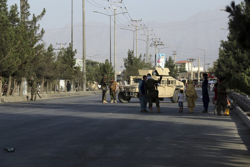 Taliban fighters stand guard at a checkpoint near the gate of Hamid Karzai international Airport in Kabul, Afghanistan, Saturday, Aug. 28, 2021.  The Taliban have sealed off Kabul’s airport to most would-be evacuees to prevent large crowds from gathering after this week's deadly suicide attack. The massive U.S.-led airlift was winding down Saturday ahead of a U.S. deadline to withdraw from Afghanistan by Tuesday. (AP Photo/Wali Sabawoon)