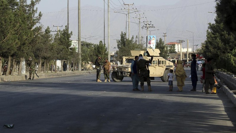 Taliban fighters stand guard at a checkpoint near the gate of Hamid Karzai international Airport in Kabul, Afghanistan, Saturday, Aug. 28, 2021.  The Taliban have sealed off Kabul’s airport to most would-be evacuees to prevent large crowds from gathering after this week's deadly suicide attack. The massive U.S.-led airlift was winding down Saturday ahead of a U.S. deadline to withdraw from Afghanistan by Tuesday. (AP Photo/Wali Sabawoon)