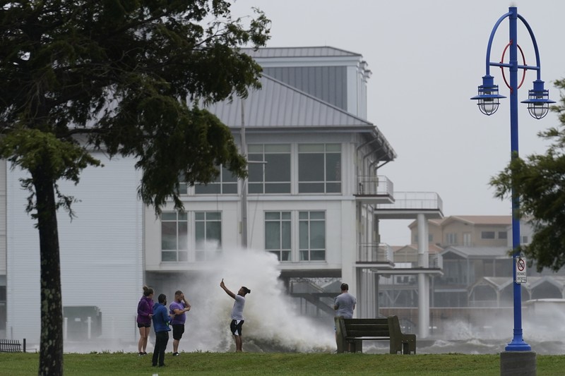 A man passes by a section of roof that was blown off of a building in the French Quarter by Hurricane Ida winds, Sunday, Aug. 29, 2021, in New Orleans. (AP Photo/Eric Gay)