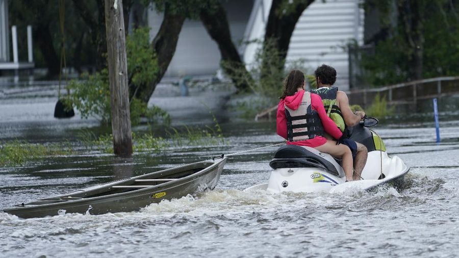 A man passes by a section of roof that was blown off of a building in the French Quarter by Hurricane Ida winds, Sunday, Aug. 29, 2021, in New Orleans. (AP Photo/Eric Gay)