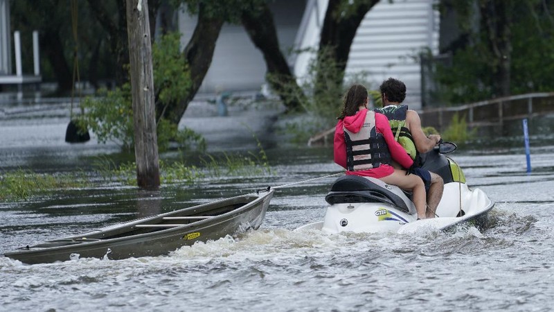 A man passes by a section of roof that was blown off of a building in the French Quarter by Hurricane Ida winds, Sunday, Aug. 29, 2021, in New Orleans. (AP Photo/Eric Gay)