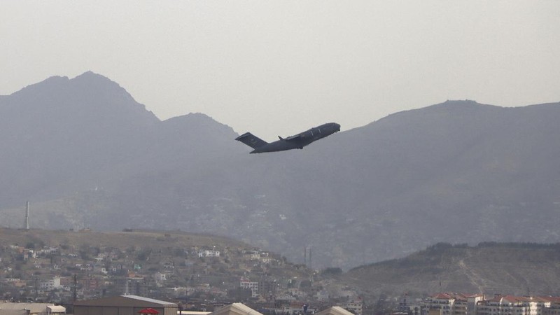 Taliban fighters hold Taliban flags in Kabul, Afghanistan, Monday, Aug. 30, 2021. Many Afghans are anxious about the Taliban rule and are figuring out ways to get out of Afghanistan. But it's the financial desperation that seems to hang heavy over the city. (AP Photo/Khwaja Tawfiq Sediqi)