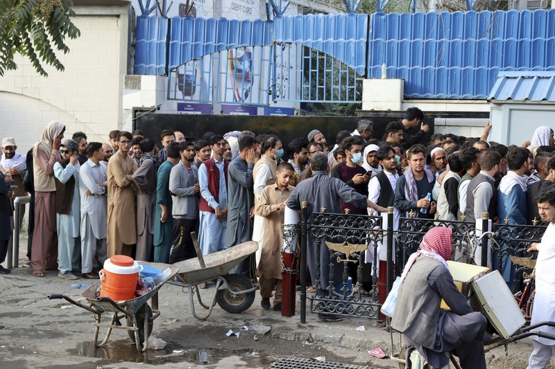 Taliban fighters hold Taliban flags in Kabul, Afghanistan, Monday, Aug. 30, 2021. Many Afghans are anxious about the Taliban rule and are figuring out ways to get out of Afghanistan. But it's the financial desperation that seems to hang heavy over the city. (AP Photo/Khwaja Tawfiq Sediqi)