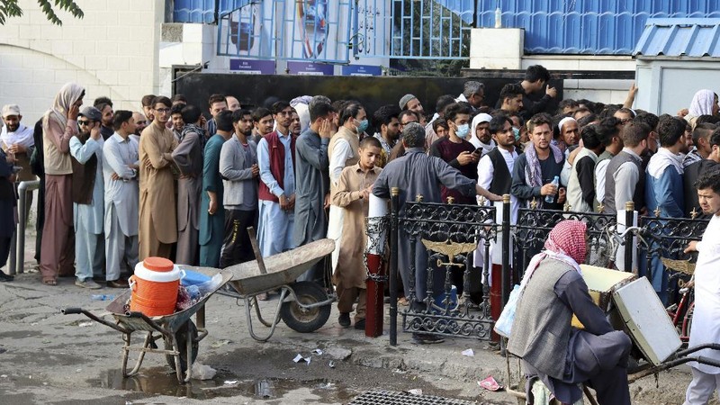 Taliban fighters hold Taliban flags in Kabul, Afghanistan, Monday, Aug. 30, 2021. Many Afghans are anxious about the Taliban rule and are figuring out ways to get out of Afghanistan. But it's the financial desperation that seems to hang heavy over the city. (AP Photo/Khwaja Tawfiq Sediqi)