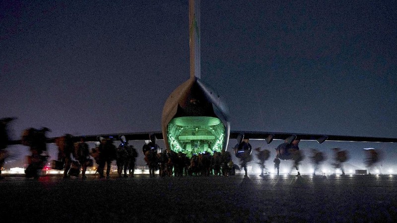 In this Aug. 30, 2021, photo provided by the U.S. Air Force, soldiers, assigned to the 82nd Airborne Division, prepare to board a U.S. Air Force C-17 Globemaster III aircraft at Hamid Karzai International Airport in Kabul, Afghanistan. (Senior Airman Taylor Crul/U.S. Air Force via AP)