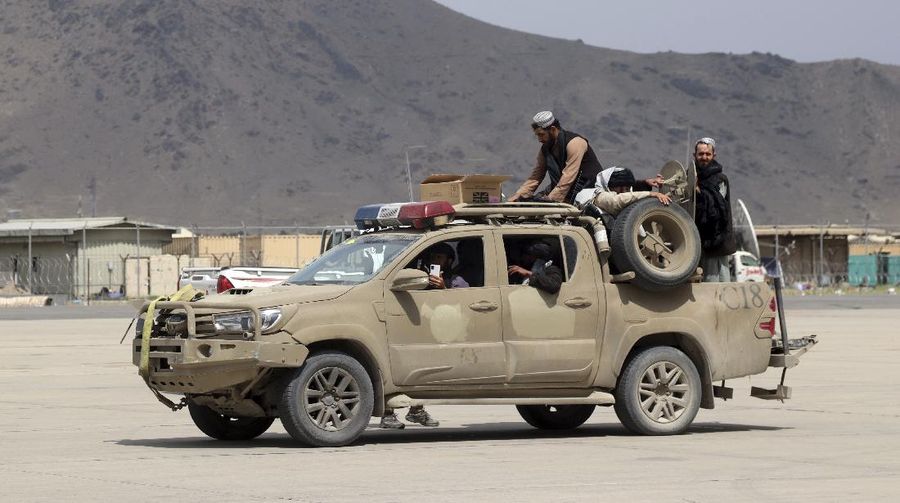 Taliban fighters arrive inside the Hamid Karzai International Airport after the U.S. military's withdrawal, in Kabul, Afghanistan, Tuesday, Aug. 31, 2021. The Taliban were in full control of Kabul's airport on Tuesday, after the last U.S. plane left its runway, marking the end of America's longest war. (AP Photo/Khwaja Tawfiq Sediqi)