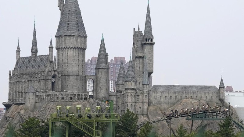 Visitors wearing masks prepare to visit the Universal Studios theme park during trial runs in Beijing, China, Tuesday, Aug. 31, 2021. Universal Studios announced Monday, Aug. 30, 2021, that its first theme park in China will open in the country's capital in September. The company set the opening date for Sept. 20, according to a statement and video posted on the Chinese social media site WeChat. (AP Photo/Ng Han Guan)