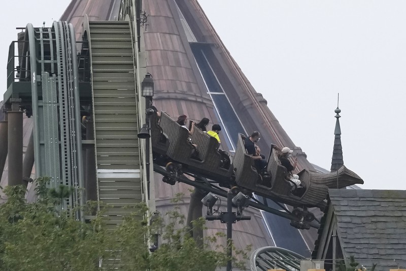Visitors wearing masks prepare to visit the Universal Studios theme park during trial runs in Beijing, China, Tuesday, Aug. 31, 2021. Universal Studios announced Monday, Aug. 30, 2021, that its first theme park in China will open in the country's capital in September. The company set the opening date for Sept. 20, according to a statement and video posted on the Chinese social media site WeChat. (AP Photo/Ng Han Guan)