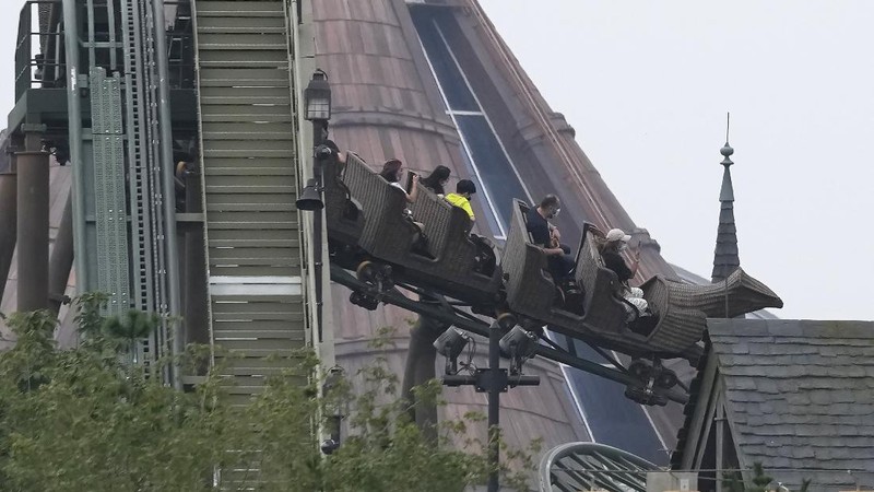 Visitors wearing masks prepare to visit the Universal Studios theme park during trial runs in Beijing, China, Tuesday, Aug. 31, 2021. Universal Studios announced Monday, Aug. 30, 2021, that its first theme park in China will open in the country's capital in September. The company set the opening date for Sept. 20, according to a statement and video posted on the Chinese social media site WeChat. (AP Photo/Ng Han Guan)