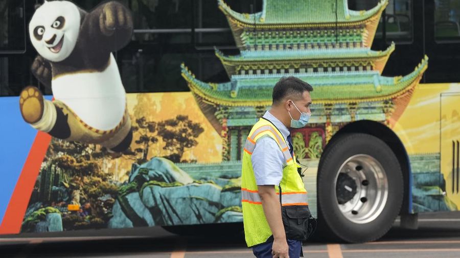 Visitors wearing masks prepare to visit the Universal Studios theme park during trial runs in Beijing, China, Tuesday, Aug. 31, 2021. Universal Studios announced Monday, Aug. 30, 2021, that its first theme park in China will open in the country's capital in September. The company set the opening date for Sept. 20, according to a statement and video posted on the Chinese social media site WeChat. (AP Photo/Ng Han Guan)