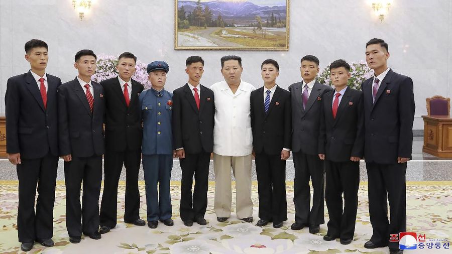 In this undated photo provided by the North Korean government on Tuesday, Aug. 31, 2021, North Korean leader Kim Jong Un, center, meets the participants in Youth Day celebrations during a photo session at an undisclosed place in North Korea. Independent journalists were not given access to cover the event depicted in this image distributed by the North Korean government. The content of this image is as provided and cannot be independently verified. Korean language watermark on image as provided by source reads: 