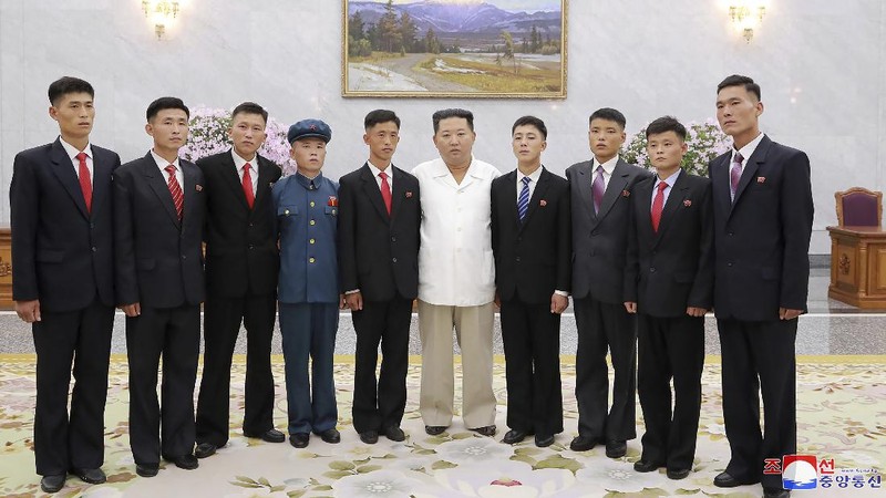 In this undated photo provided by the North Korean government on Tuesday, Aug. 31, 2021, North Korean leader Kim Jong Un, center, meets the participants in Youth Day celebrations during a photo session at an undisclosed place in North Korea. Independent journalists were not given access to cover the event depicted in this image distributed by the North Korean government. The content of this image is as provided and cannot be independently verified. Korean language watermark on image as provided by source reads: 