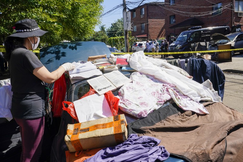 Banjir New York Akibat Badai Ida A resident of 153rd St. in the Flushing neighborhood of the Queens borough of New York sits outside her home with her water logged belongings, Thursday, Sept. 2, 2021, in New York. The remnants of Hurricane Ida dumped historic rain over New York City, with several deaths linked to flooding in the region as basement apartments suddenly filled with water and freeways and boulevards turned into rivers, submerging cars.(AP Photo/Mary Altaffer)